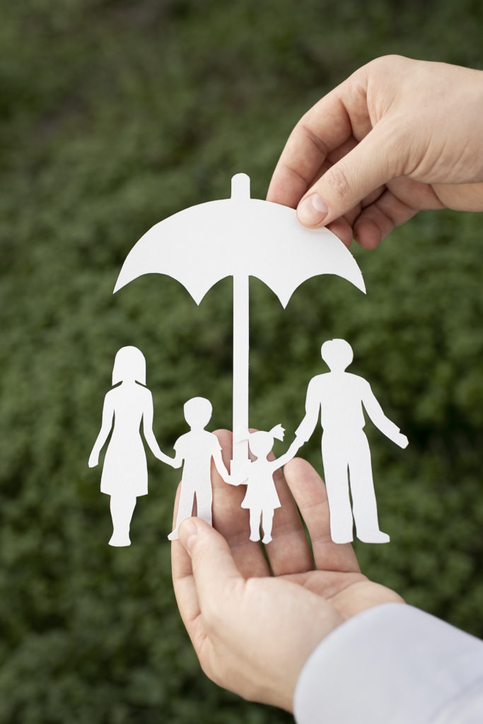 close-up-hands-holding-paper-family-outdoors-1